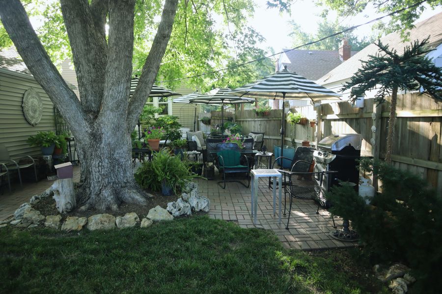 patio with seating areas and pots with plants