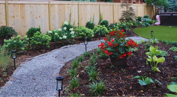 shade garden with gravel path and lights