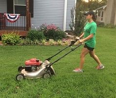 Youth mowing the lawn