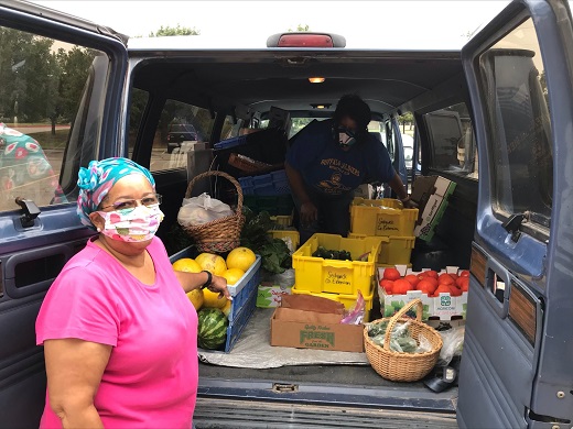 Donna Pearson McClish, owner and operator of Common Ground Producers and Growers, Inc., collects produce donations for use in their food box program.  Assisting her is Sharon Gaither.
